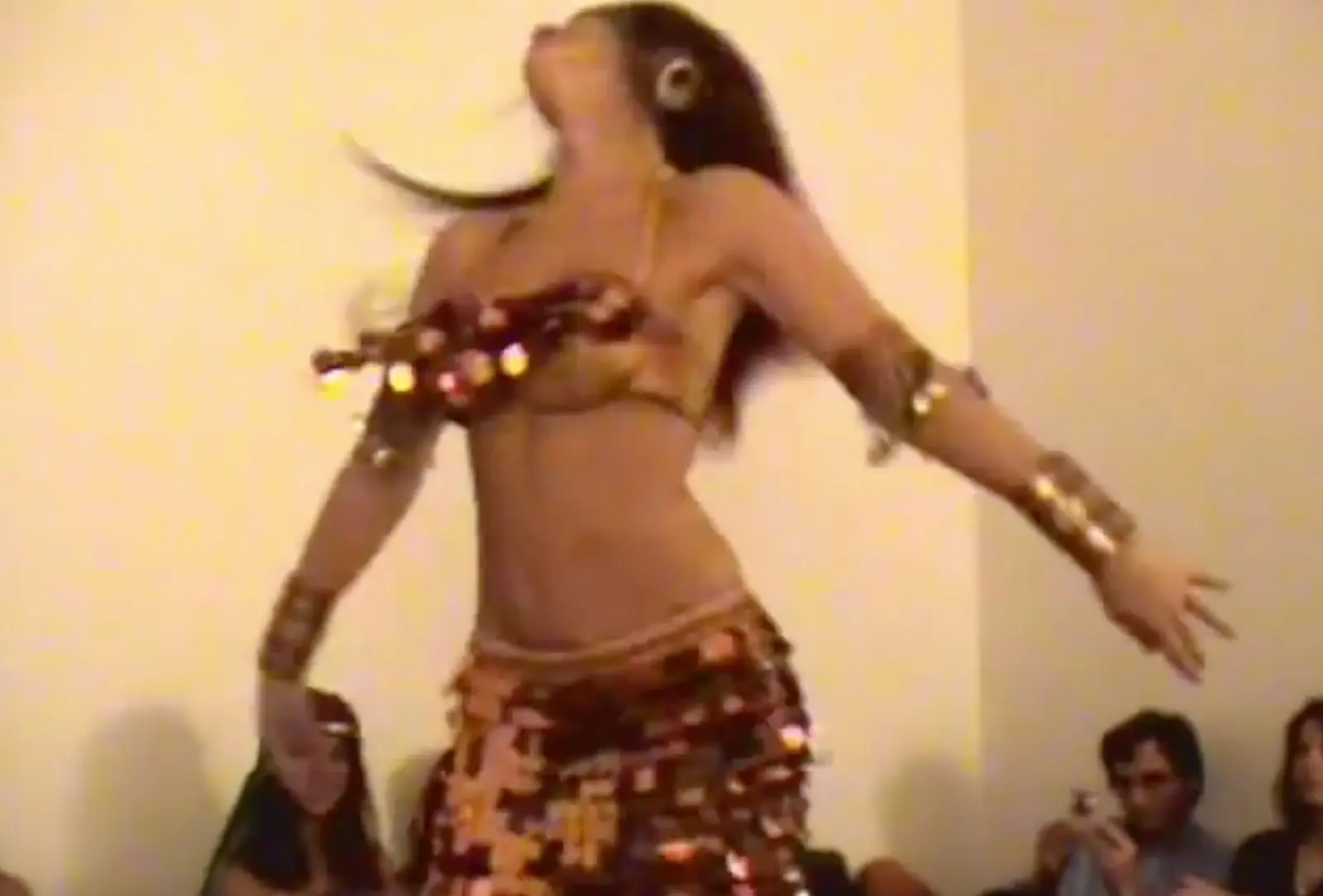 Ana spinning in a gold coin costume, in front of the audience