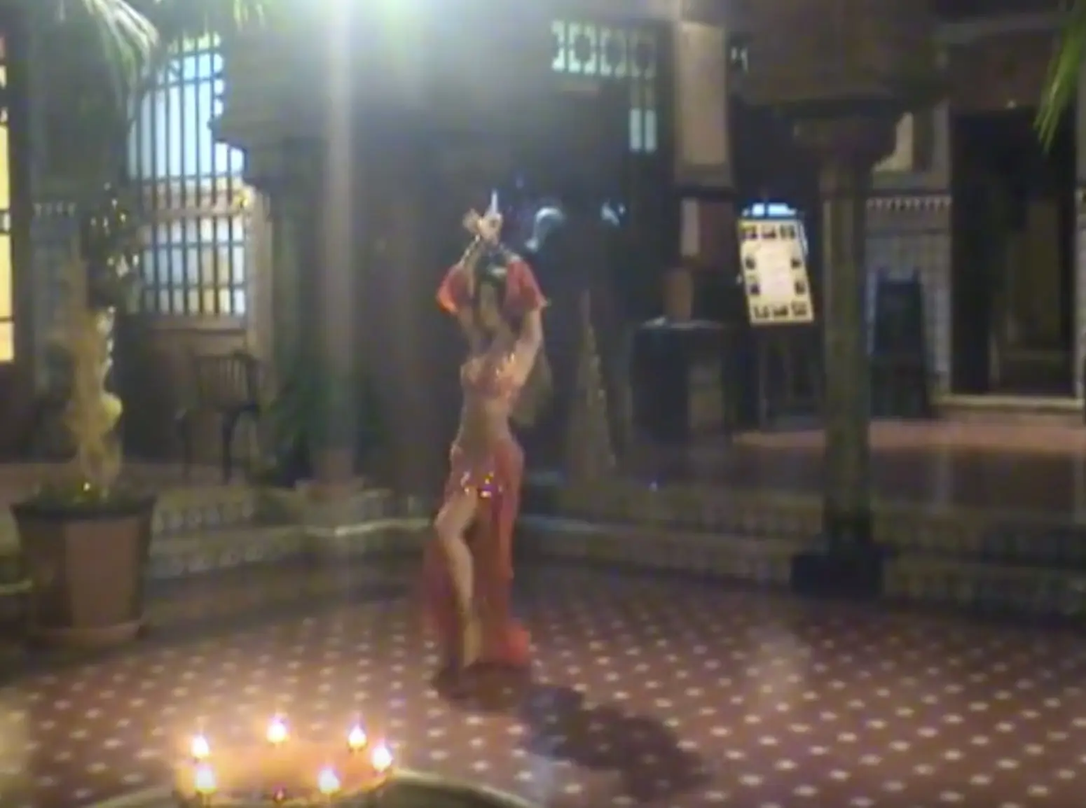 Ana dancing in a Moorish-style hall, with candles lit on the floor
