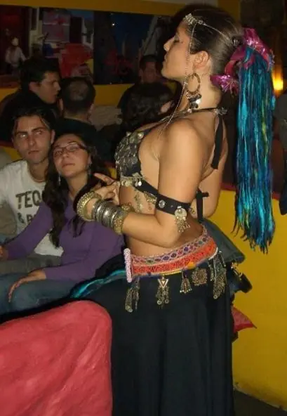 Ana in a tribal-style costume with turquoise yarn falls in her hair